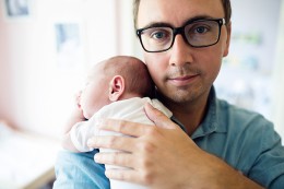 Young father holding newborn